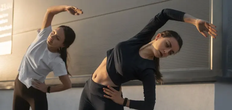 women-stretching-together-before-working-out-outdoors